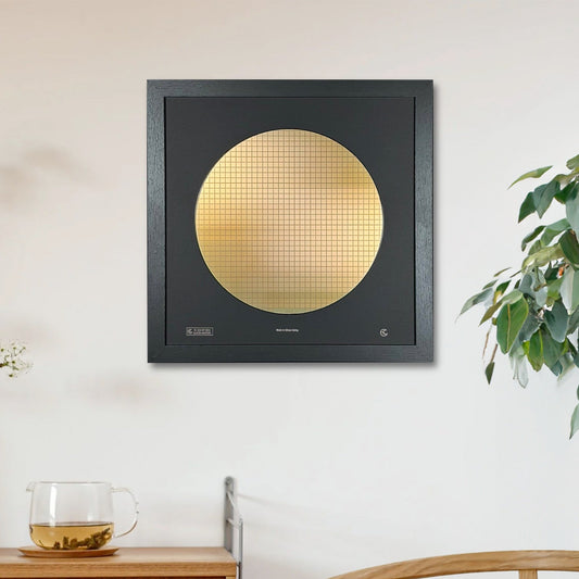 Modern interior with a gold circular artwork on a black frame, wooden cabinet, and chair.