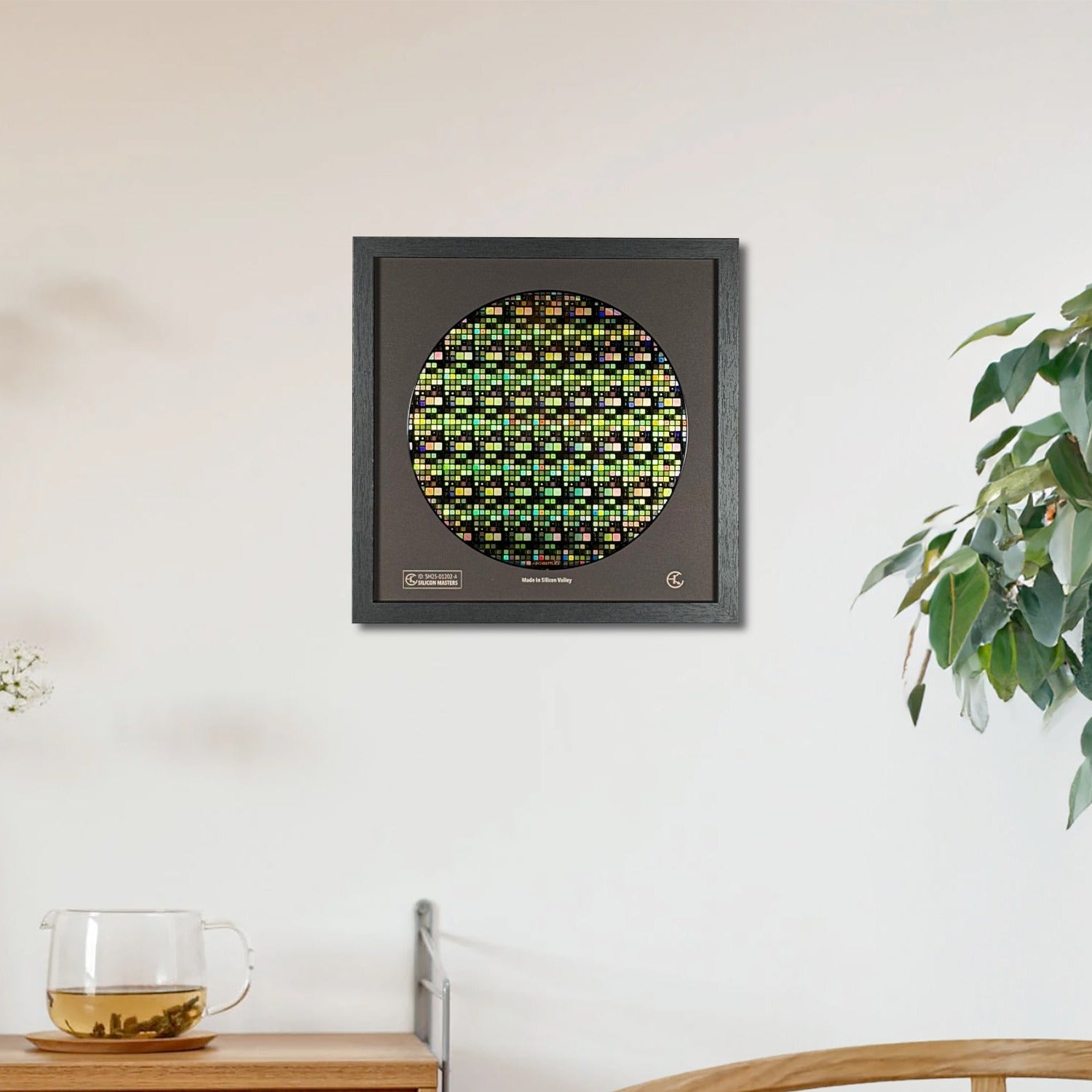 Decorative wall art piece with a circular design on a white wall, next to a wooden cabinet and a plant.
