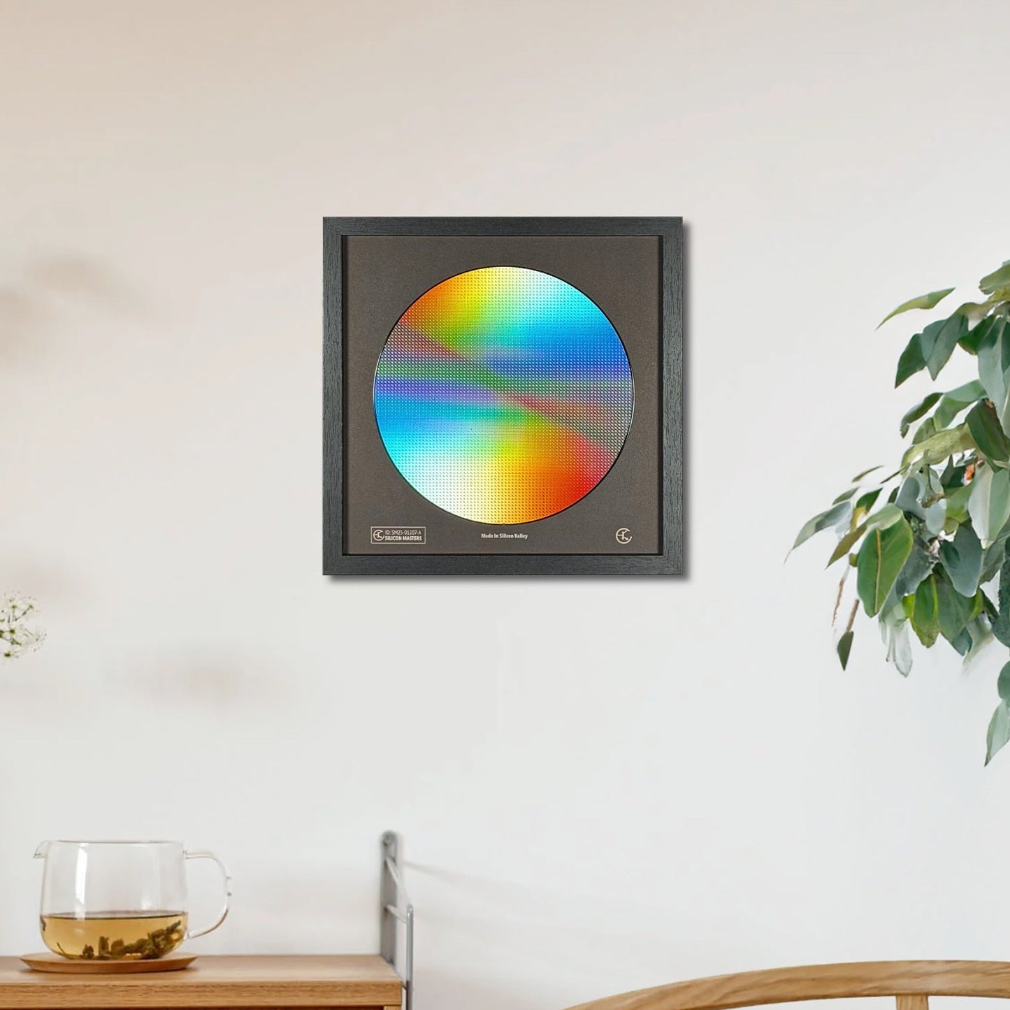 Color wheel art piece on a wall in a room with a wooden cabinet and plant.